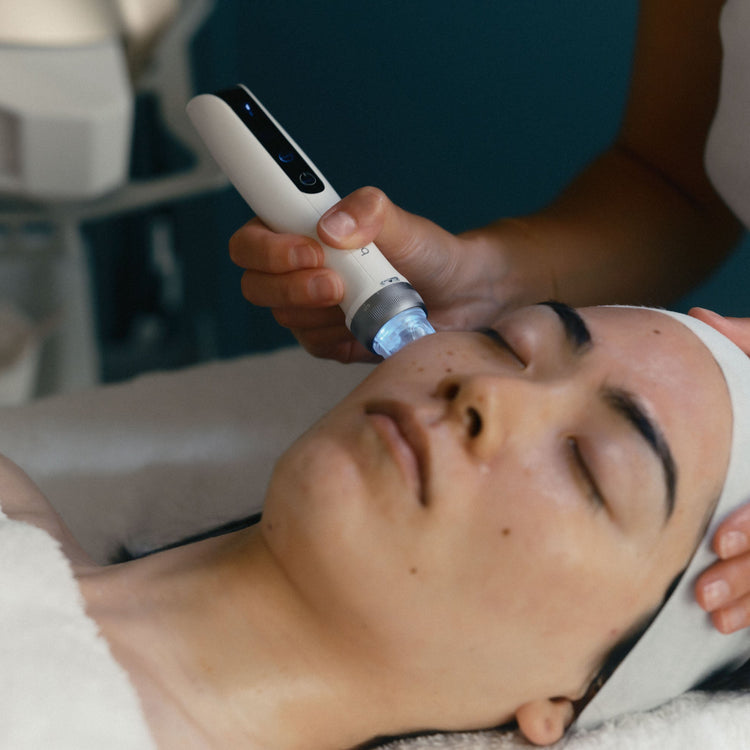 Person receiving a facial treatment with a device on their face